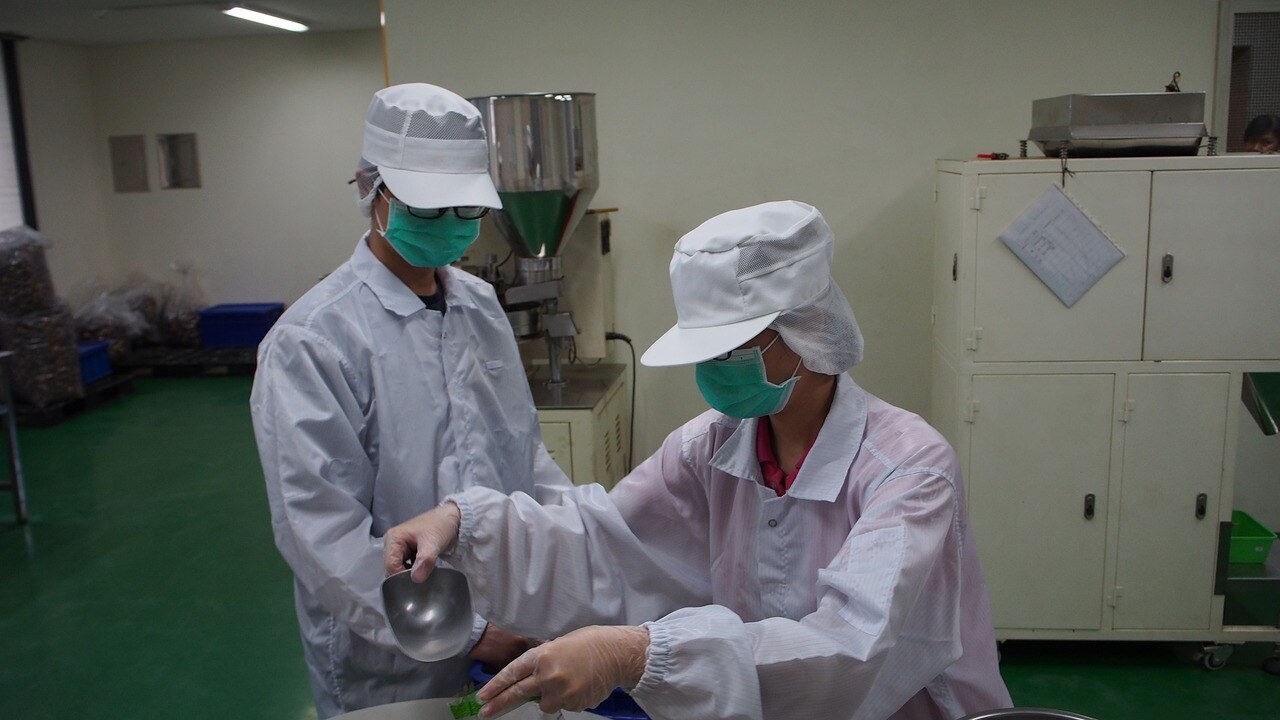 Two workers in a food wareohouse on newly installed food grade flooring that is hygienically safe for the environment. 