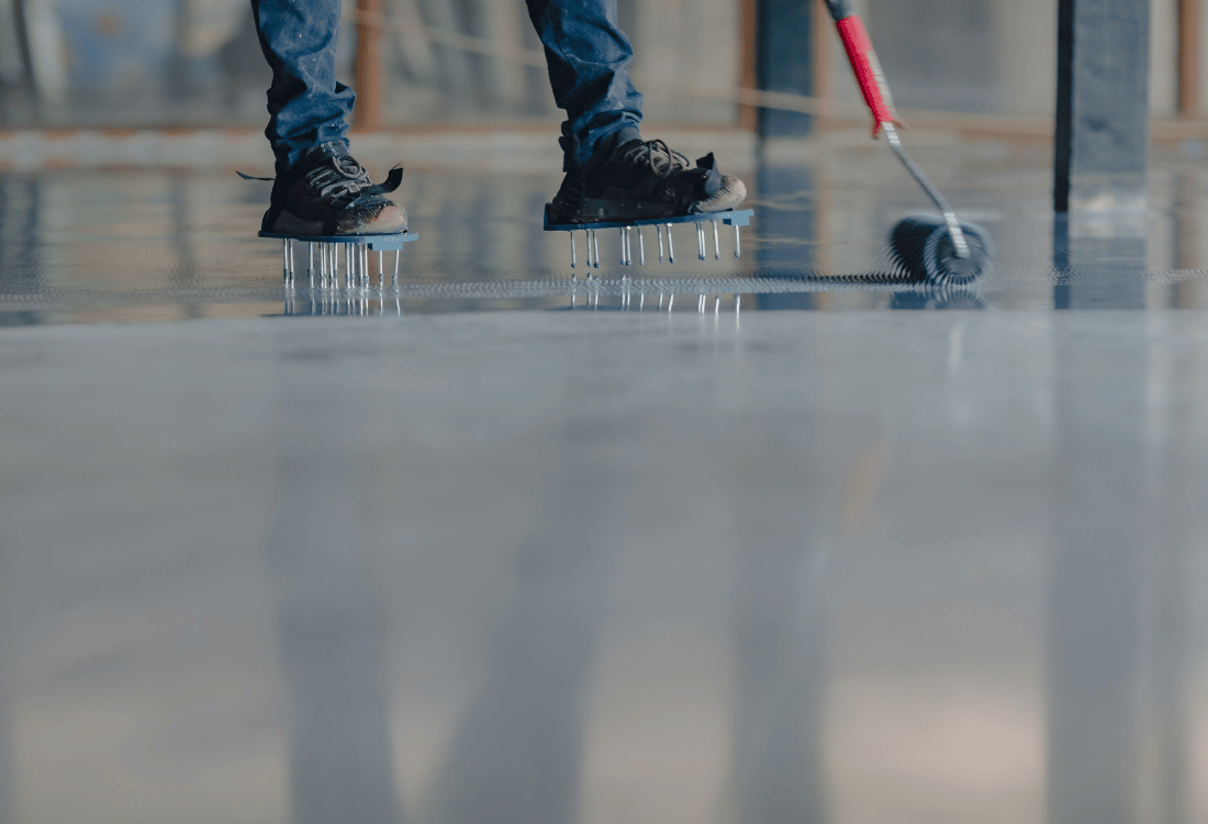 Resinous flooring installation by an expert in a warehouse to upgrade old resin floor. 